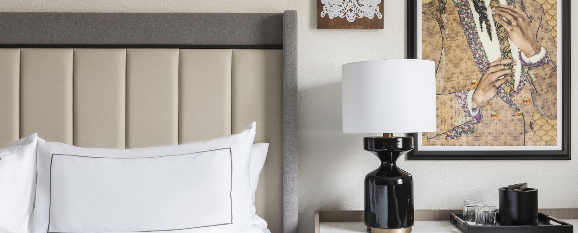 Pictures on a Wall Next to a Comfortable Bed