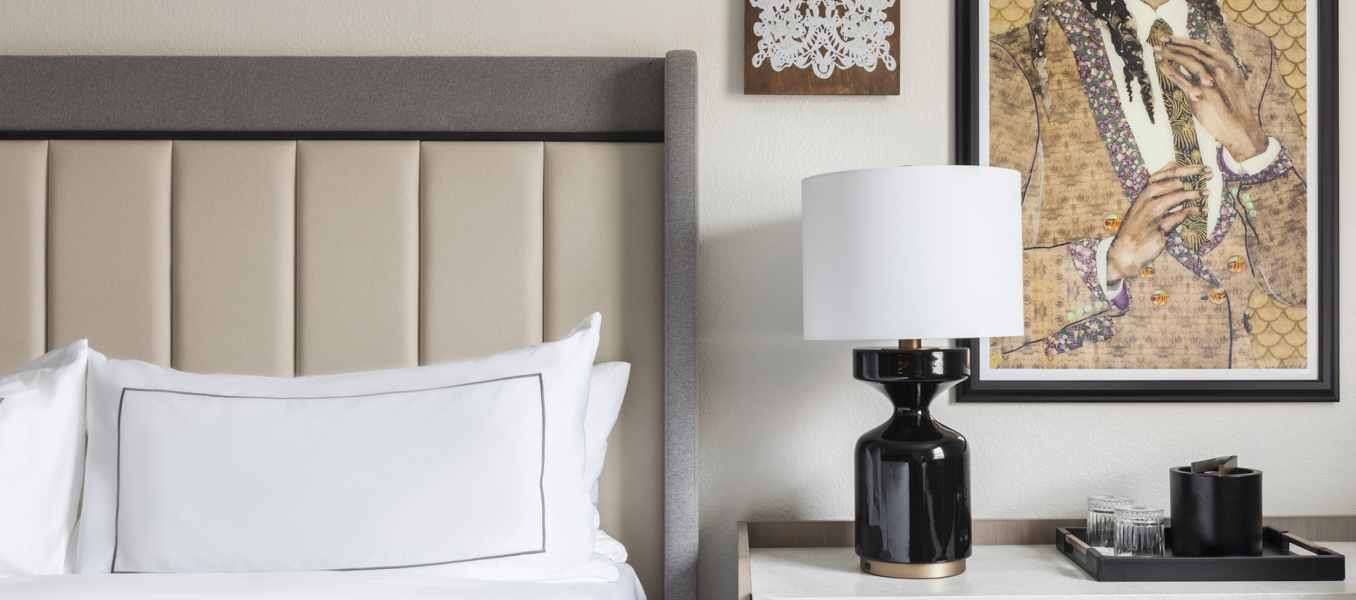 Pictures on a Wall Next to a Comfortable Bed