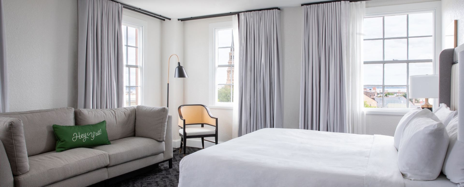King bed in room with windows and couch