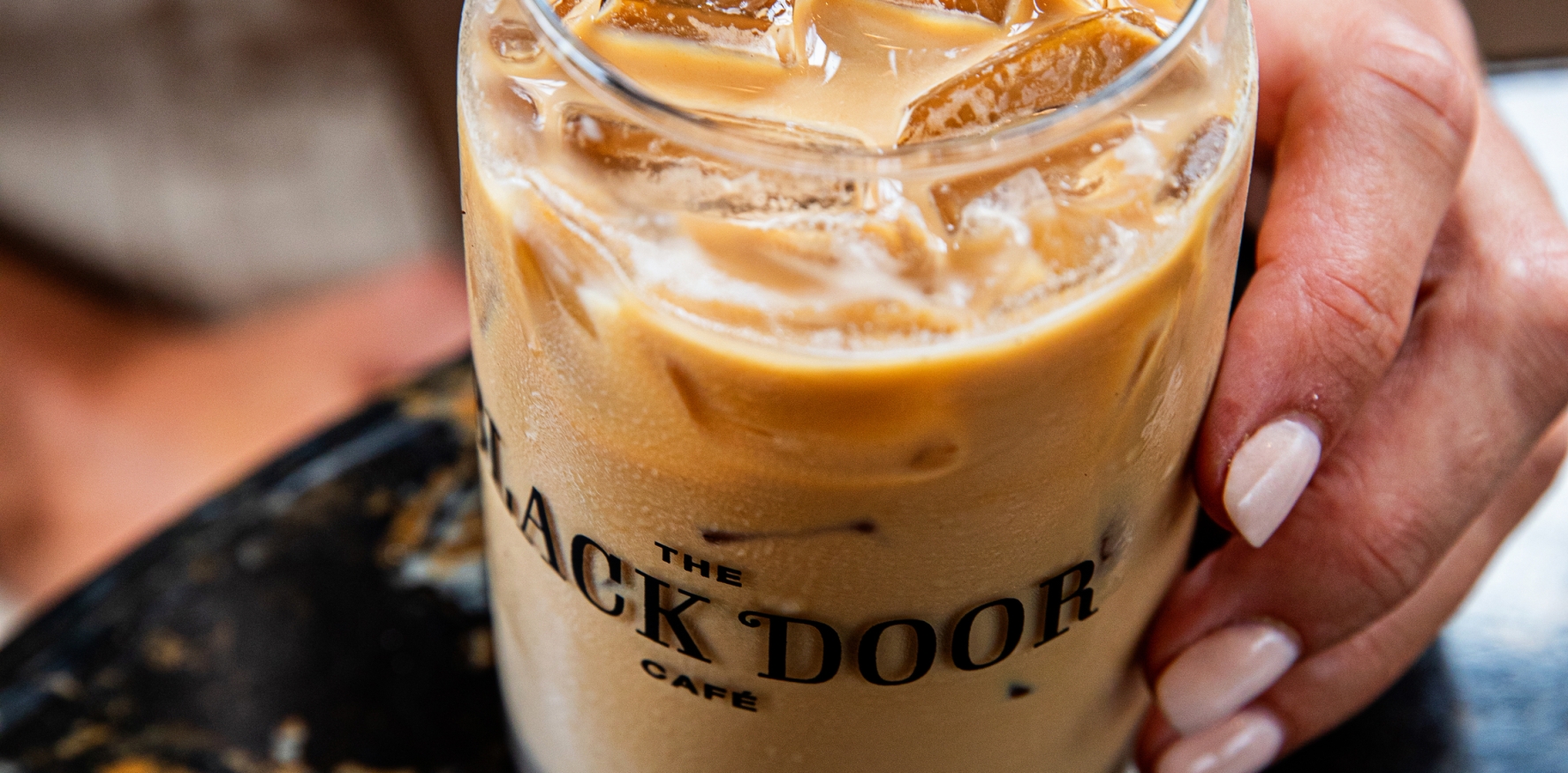 Black Door Cafe Iced coffee in branded glass