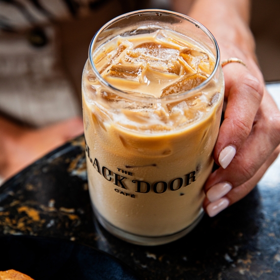 Black Door Cafe Iced coffee in branded glass